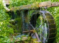 The water wheel  which is at the end of the ponds , but at the beginning of the woods